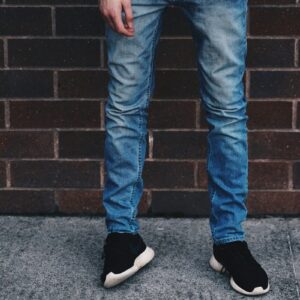 man in blue denim jeans standing