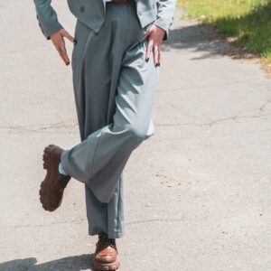 a man in a suit and tie walking down a street