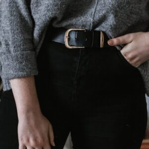 person wearing black leather belt