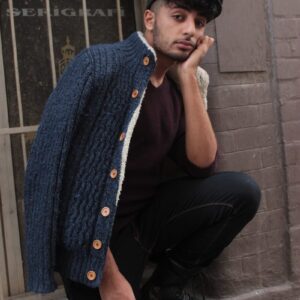 man leaning on wall with hand on chin