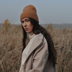 a woman standing in a field of tall grass