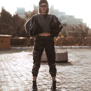 woman wearing black knit cap, black sunglasses, black leather jacket, black leather pants, and black leather biker boots